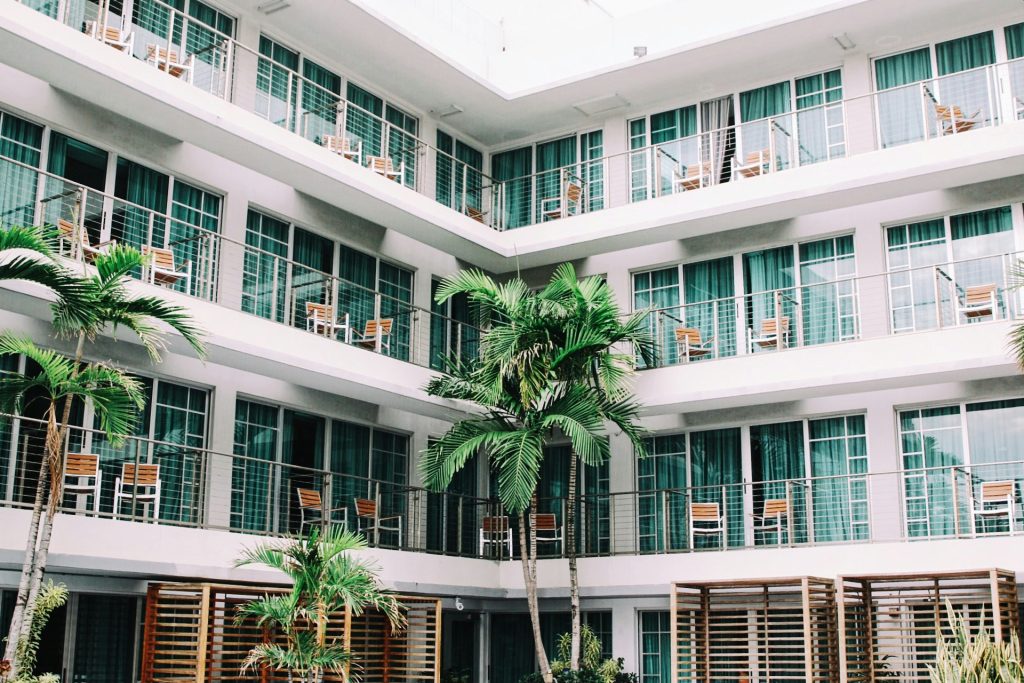 Outisde view of a hotel with palm trees