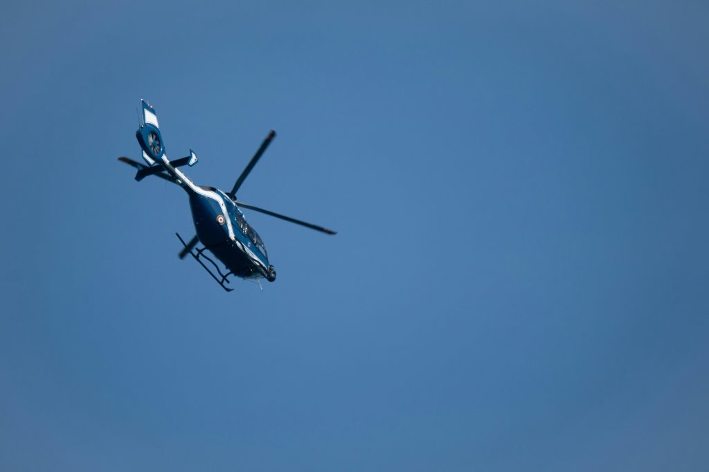 A helicopter flying in clear, open skies