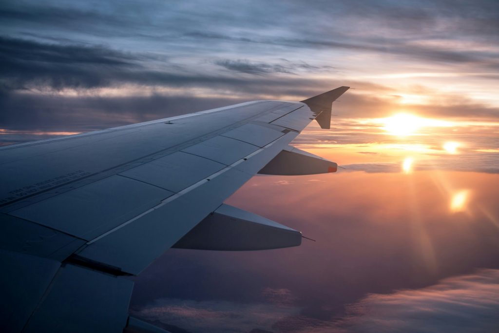 Airplane flying in the sky during sunset or sunrise
