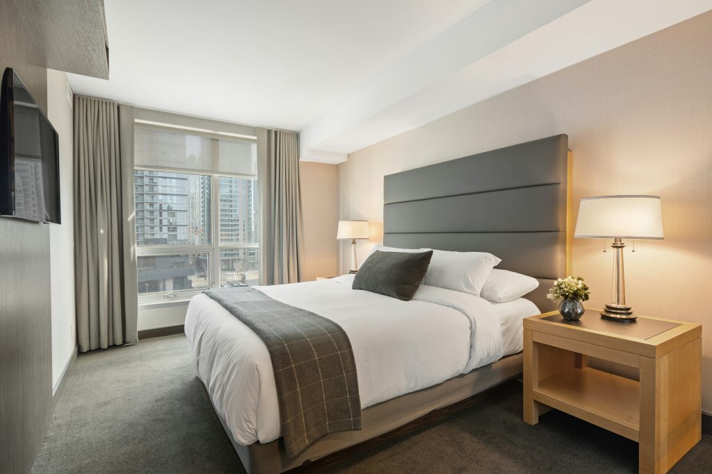 A clean hotel room with the bed made